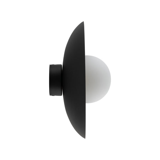 SLATE black wall sconce lit, showing the even glow through the opal glass