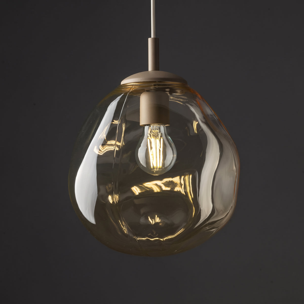 LAVA Medium pendant in a warm neutral interior with wood and stone