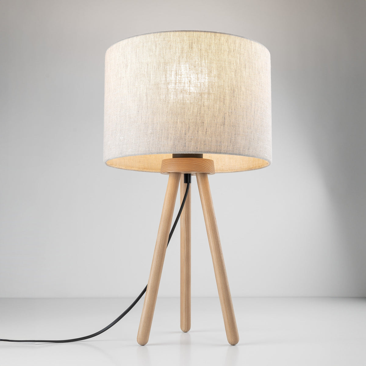 TOKYO linen table lamp lit, soft ambient glow through the shade
