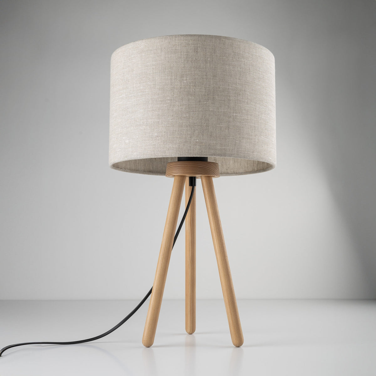 TOKYO natural linen table lamp beside a bed